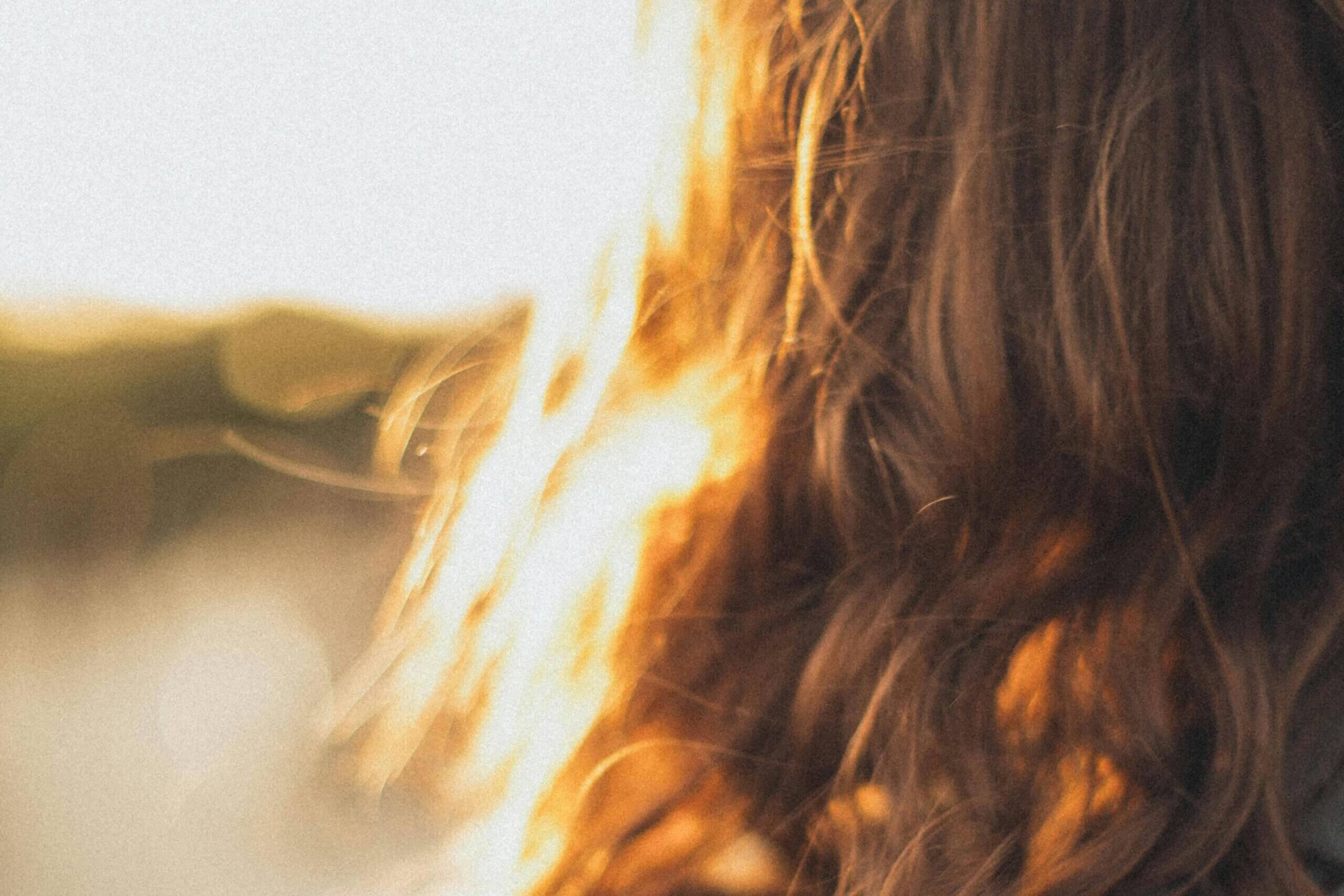 Close up of the back of a woman's head with long hair.