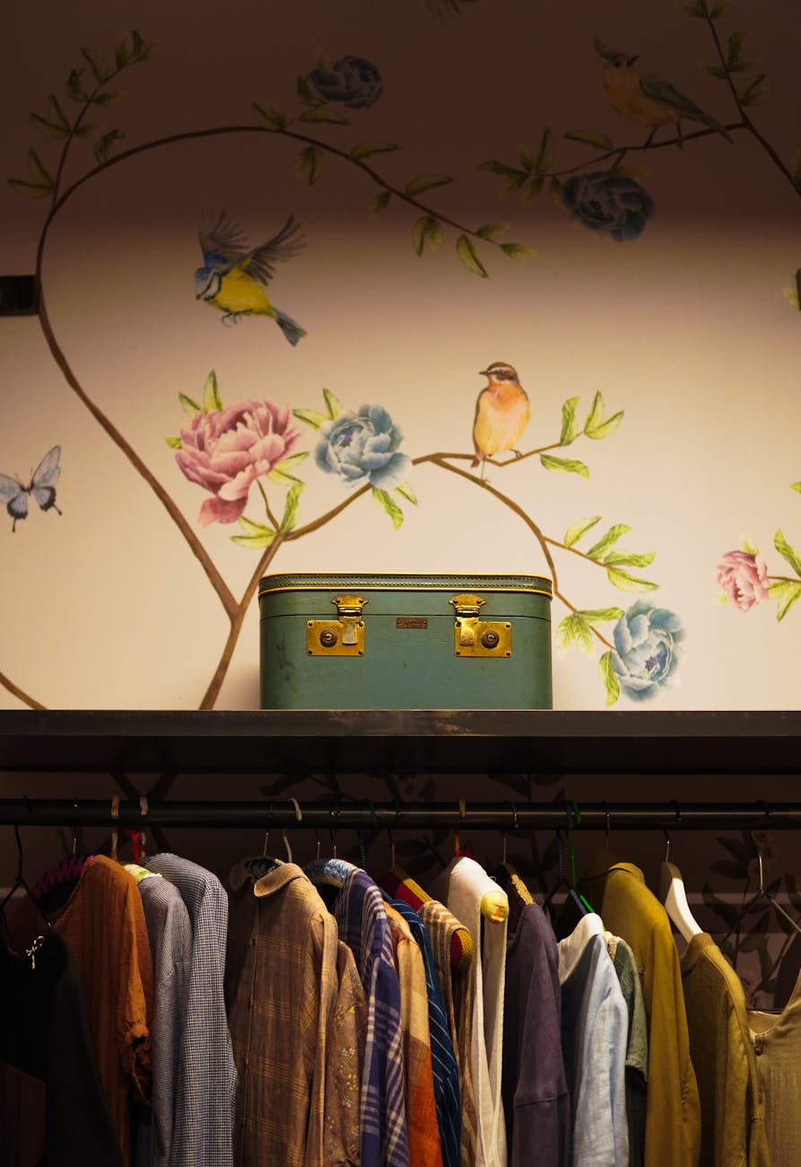 green suitcase on shelf in wardrobe