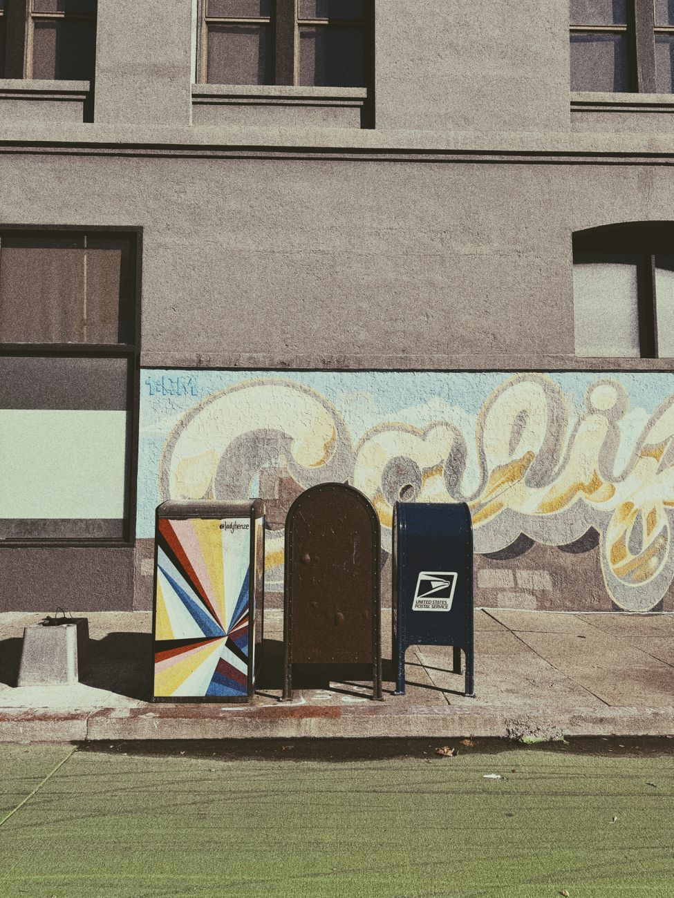 colorful mailboxes on urban sidewalk